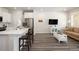 Open-concept living space with modern flooring, kitchen with bar seating, and a comfortable living area for gatherings at 11228 Bella Vita Dr, Broomfield, CO 80020