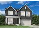 Charming two-story home with a modern dark gray exterior, attached garage, and inviting front porch seating at 7175 S Youngfield Way, Littleton, CO 80127