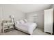 Spacious bedroom with a queen-size bed, light walls, and a large window at 16053 E Radcliff Pl # B, Aurora, CO 80015