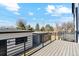Large back deck with metal railings and view of the backyard and neighborhood trees at 2321 S Galapago St, Denver, CO 80223
