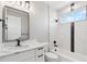 Well-lit bathroom with modern fixtures, marble countertops, and a shower-tub combo at 2321 S Galapago St, Denver, CO 80223