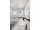 Modern bathroom featuring a glass enclosed shower and modern soaking tub at 2321 S Galapago St, Denver, CO 80223