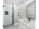 Modern bathroom featuring a glass walk-in shower, marble backsplash and vanity with black hardware at 2321 S Galapago St, Denver, CO 80223
