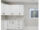 Modern kitchen featuring white cabinets, marble backsplash, and a bright window at 2321 S Galapago St, Denver, CO 80223