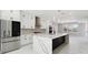 Modern kitchen with white cabinets, stainless steel appliances, and marble countertops and backsplash at 2321 S Galapago St, Denver, CO 80223