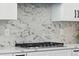Modern kitchen with stainless steel range and marble backsplash at 2321 S Galapago St, Denver, CO 80223