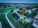 Aerial view of the house, community and the neighborhood walking path at dusk at 5163 E 123Rd Ct, Thornton, CO 80241