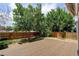 The backyard has a large wood deck perfect for entertaining, with a grass area and mature trees at 5163 E 123Rd Ct, Thornton, CO 80241