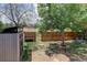 The spacious backyard has a grass area, mature trees and an open fence line at 5163 E 123Rd Ct, Thornton, CO 80241