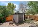 The backyard has a shed, wood fence, stairs and grass area at 5163 E 123Rd Ct, Thornton, CO 80241