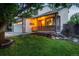 Charming home with a covered porch, stone accents, and a well-manicured lawn at 5163 E 123Rd Ct, Thornton, CO 80241