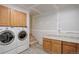 Unfinished laundry room space with cabinets, washer, dryer hookups, and stairs at 5163 E 123Rd Ct, Thornton, CO 80241