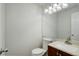 Clean and tidy powder room with vanity, mirror, and white fixtures at 5163 E 123Rd Ct, Thornton, CO 80241