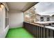 Outdoor balcony space with green turf flooring and metal railings overlooking a neighborhood at 7110 S Gaylord St # L7, Centennial, CO 80122