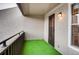Outdoor balcony space with green turf flooring and metal railings at 7110 S Gaylord St # L7, Centennial, CO 80122