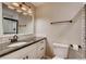 Modern bathroom boasts a vanity with granite countertop and a mirror with stylish lighting at 7110 S Gaylord St # L7, Centennial, CO 80122