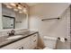 Modern bathroom boasts a vanity with granite countertop and a mirror with stylish lighting at 7110 S Gaylord St # L7, Centennial, CO 80122