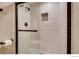 Bathroom shower with glass doors, white subway tile, and a tile accent at 7110 S Gaylord St # L7, Centennial, CO 80122