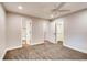 Bedroom with a ceiling fan, carpet, and view into bathroom and walk-in closet at 7110 S Gaylord St # L7, Centennial, CO 80122