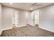 Bedroom with carpet, view into bathroom and walk-in closet at 7110 S Gaylord St # L7, Centennial, CO 80122