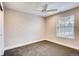 Bedroom featuring plush carpet, window view and a ceiling fan at 7110 S Gaylord St # L7, Centennial, CO 80122