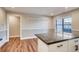 Bright dining area with wood-look floors, view of kitchen with granite counters at 7110 S Gaylord St # L7, Centennial, CO 80122