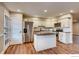 Bright kitchen with granite counters, white cabinets, stainless steel appliances, and wood-look floors at 7110 S Gaylord St # L7, Centennial, CO 80122
