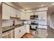 Bright kitchen featuring white cabinets, stainless steel appliances, and stylish subway tile backsplash at 7110 S Gaylord St # L7, Centennial, CO 80122