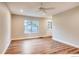 Sunlit living room with hardwood floors, a ceiling fan, and a view of the outdoors at 7110 S Gaylord St # L7, Centennial, CO 80122