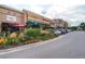 Street view of the shops and restaurants with colorful landscaping and ample parking at 7110 S Gaylord St # L7, Centennial, CO 80122