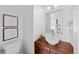 Bathroom featuring wood vanity, white vessel sink, a stylish mirror and artwork at 3131 Vallejo St, Denver, CO 80211