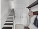 Bright foyer features a staircase, white walls, and a convenient bench with coat rack at 3131 Vallejo St, Denver, CO 80211