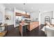 Open-concept kitchen with wood cabinets, stainless steel appliances, and a breakfast bar at 3131 Vallejo St, Denver, CO 80211