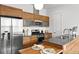 Modern kitchen featuring stainless steel appliances, wooden cabinets, and a convenient island with breakfast bar at 3131 Vallejo St, Denver, CO 80211