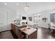Open concept living area featuring modern kitchen, cozy fireplace, comfortable seating, and abundant natural light at 3131 Vallejo St, Denver, CO 80211
