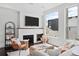 Bright living room with a modern fireplace, comfortable seating, and large windows offering neighborhood views at 3131 Vallejo St, Denver, CO 80211