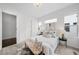 Bright main bedroom with decorative rug and pillows, featuring large windows and neutral decor at 3131 Vallejo St, Denver, CO 80211