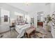 Bright main bedroom with large windows, neutral decor, and en suite bathroom access at 3131 Vallejo St, Denver, CO 80211