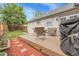 Backyard deck with outdoor seating, a grill, and access to the lawn and garden at 17499 E Whitaker Dr, Aurora, CO 80015