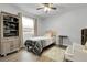 Comfortable bedroom featuring wood floors, a ceiling fan, and an accent chair at 17499 E Whitaker Dr, Aurora, CO 80015