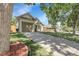 Well-maintained home with beautiful lawn and long driveway leading to an attached garage at 17499 E Whitaker Dr, Aurora, CO 80015