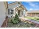 Charming home featuring a well-manicured garden, welcoming front porch and neutral siding at 17499 E Whitaker Dr, Aurora, CO 80015
