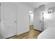 Hallway with wood flooring leading to doorways at 17499 E Whitaker Dr, Aurora, CO 80015