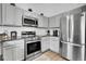 Well-equipped kitchen features stainless steel appliances and bright cabinets at 17499 E Whitaker Dr, Aurora, CO 80015