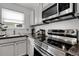 Updated kitchen includes stainless appliances, a window, and dark countertops at 17499 E Whitaker Dr, Aurora, CO 80015