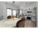 Well-lit kitchen and dining area with neutral tones and stainless-steel appliances at 17499 E Whitaker Dr, Aurora, CO 80015