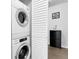 Convenient laundry room with stacked washer and dryer, plus extra storage space at 17499 E Whitaker Dr, Aurora, CO 80015