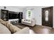 Bright living room featuring sleek laminate floors, neutral walls and furniture, and ample natural light at 17499 E Whitaker Dr, Aurora, CO 80015