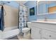 Bright, blue bathroom with shower-tub combo and white vanity at 1035 Milo Cir # B, Lafayette, CO 80026