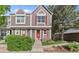 Charming two-story townhouse with red door, red shutters, and well-manicured landscaping at 1035 Milo Cir # B, Lafayette, CO 80026